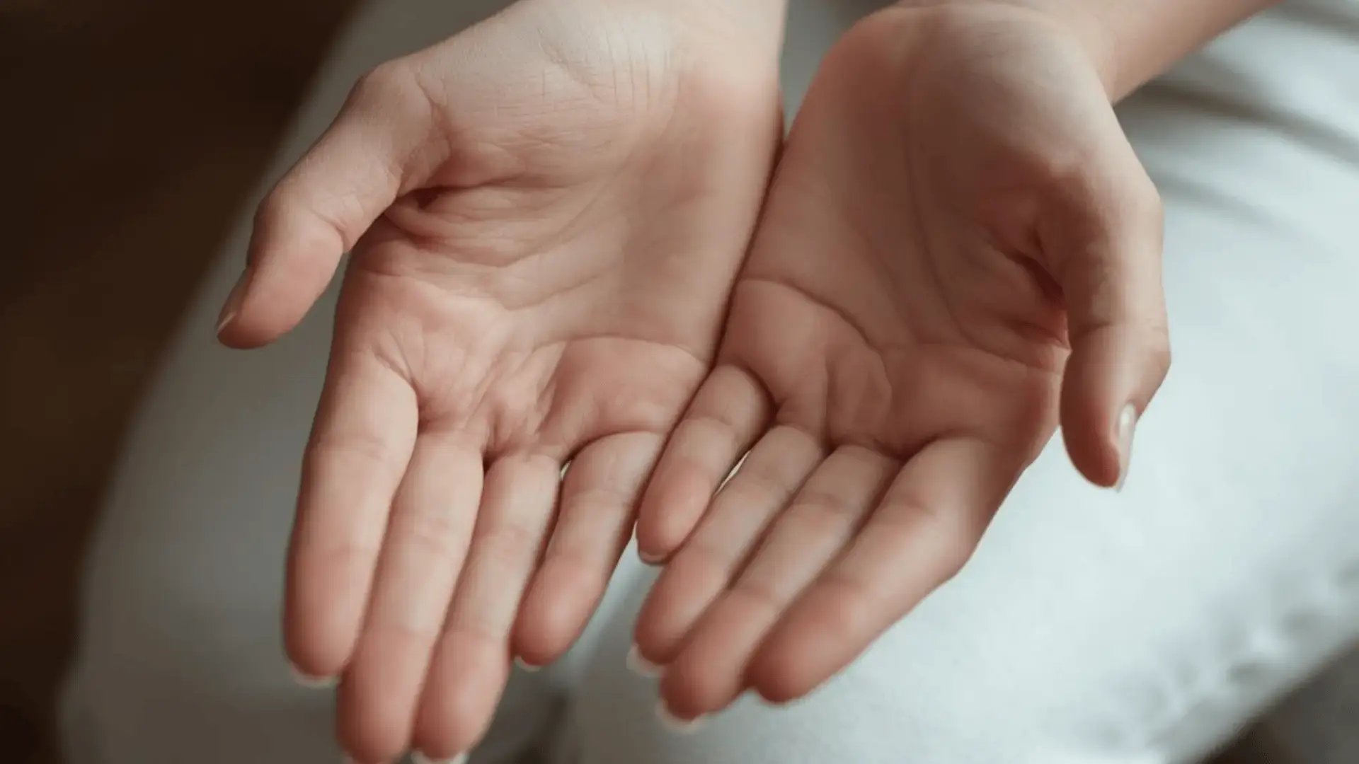 Close-up of open hands resting palms-up, conveying openness and body awareness Trauma Therapist Institute