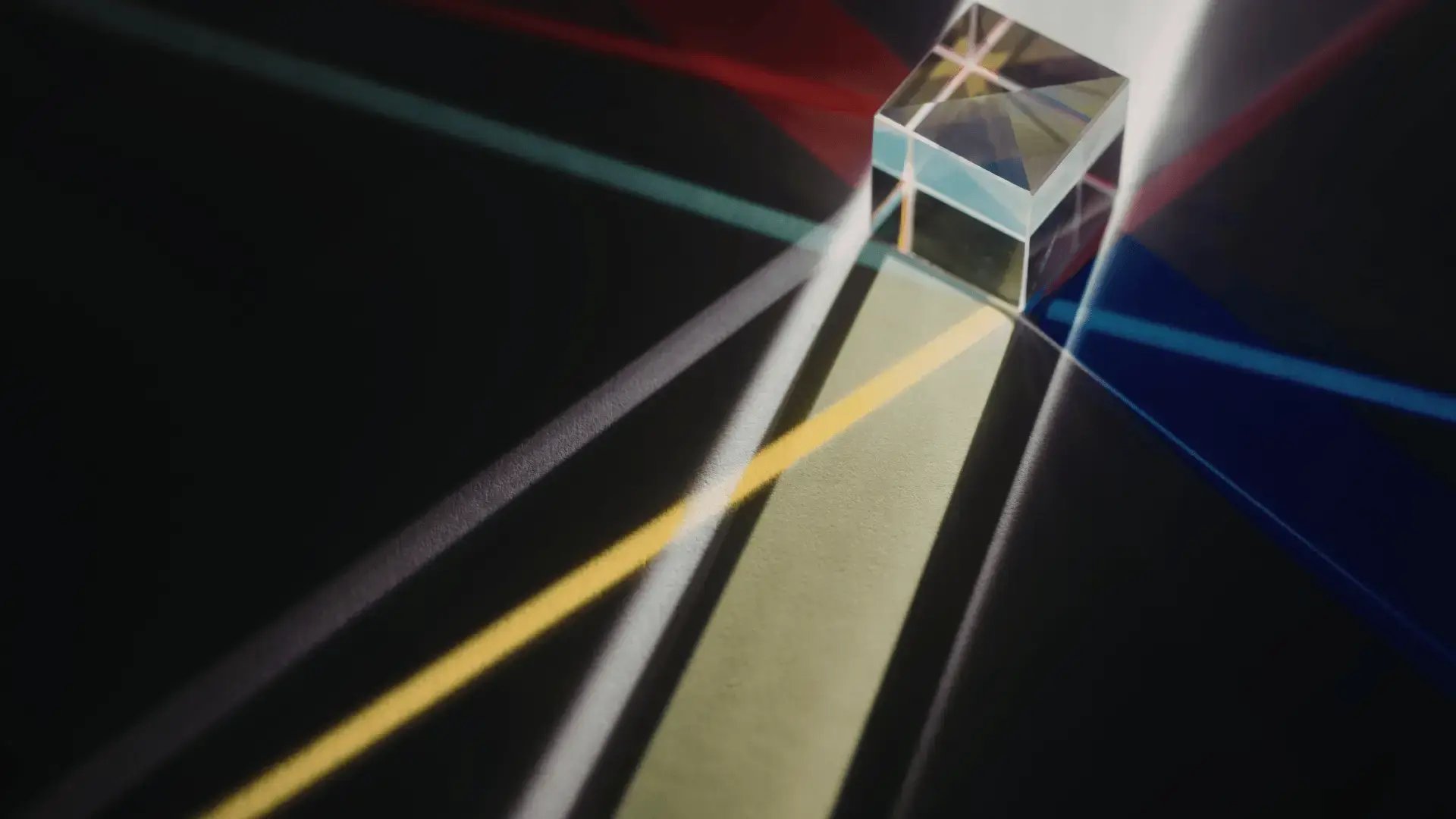 Glass prism refracting light into multiple colorful beams across a dark surface Trauma Therapist Institute